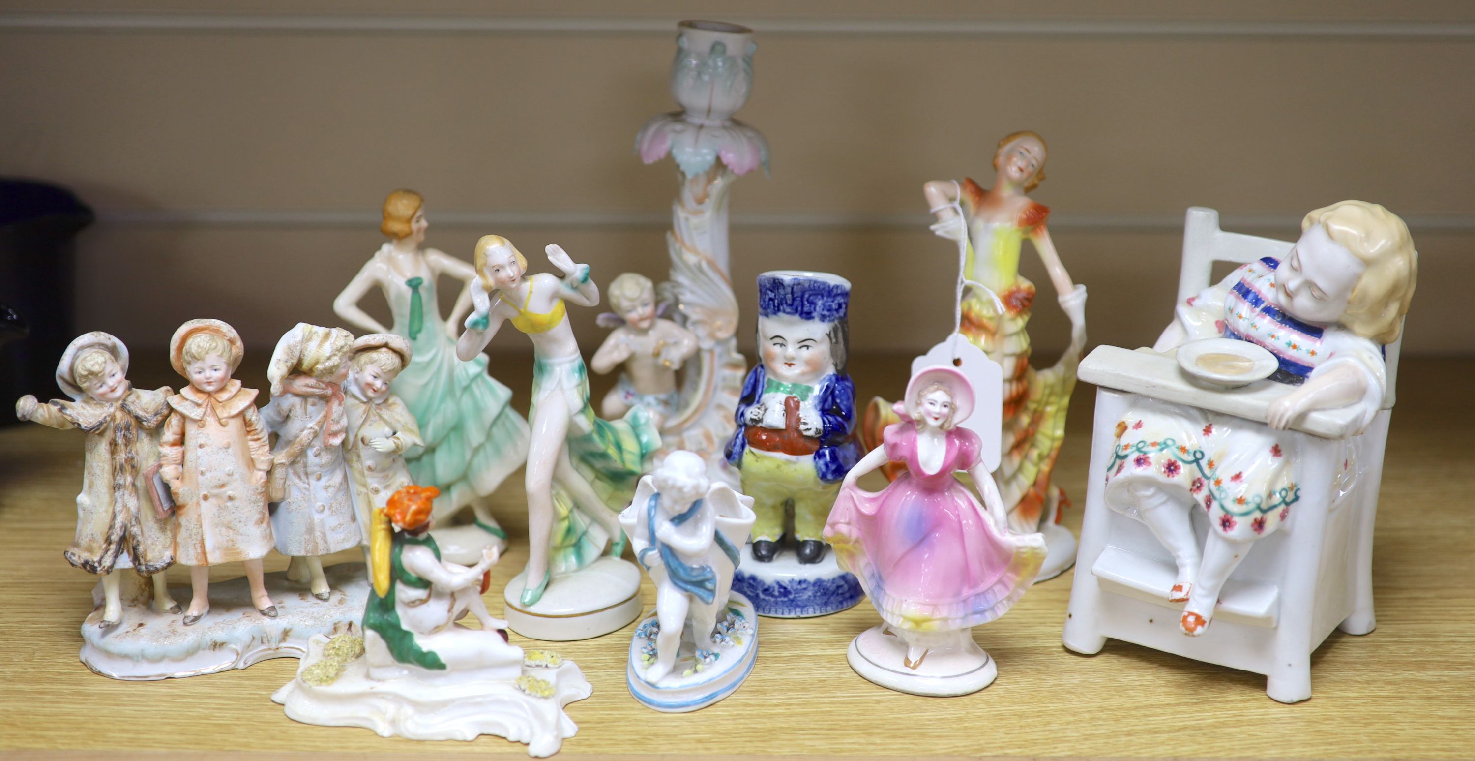 A collection of Art Deco ceramic dancing ladies, a 19th century figural box, a candlestick and a Toby jug, etc., tallest 22cm